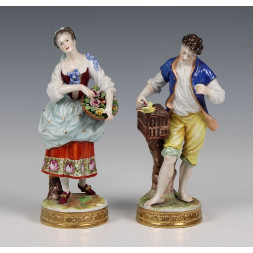 32 - A pair of Wessel, Frankenthal porcelain figures,  of a woman holding a rose and a man with a bird in... 