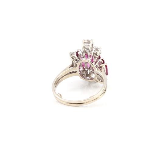 100 - A vintage 18ct white gold, ruby and diamond modernist style ring hallmarked '18CT', with two stepped... 