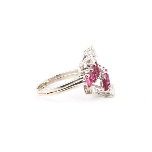 100 - A vintage 18ct white gold, ruby and diamond modernist style ring hallmarked '18CT', with two stepped... 