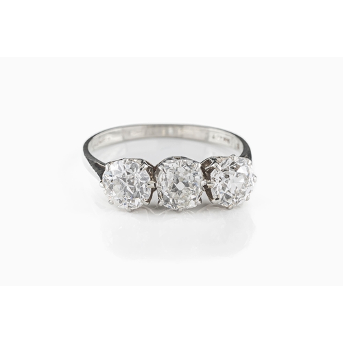 101 - An early 20th century 18ct white gold and diamond three-stone ring, the central old-cut diamond appr... 