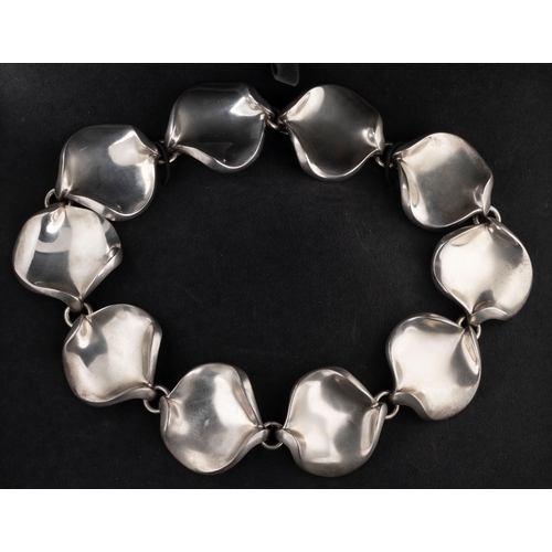 106 - Hans Hansen for Georg Jensen - A silver necklace having ten stylised petal links, approx 37cm long, ... 