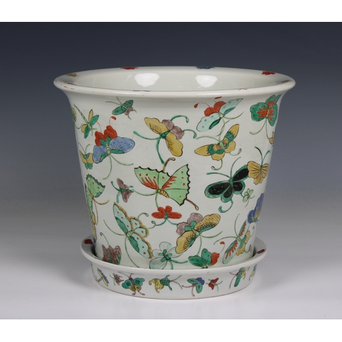 1180 - A 20th century Chinese porcelain jardiniere and saucer base decorated with polychrome butterflies, 1... 