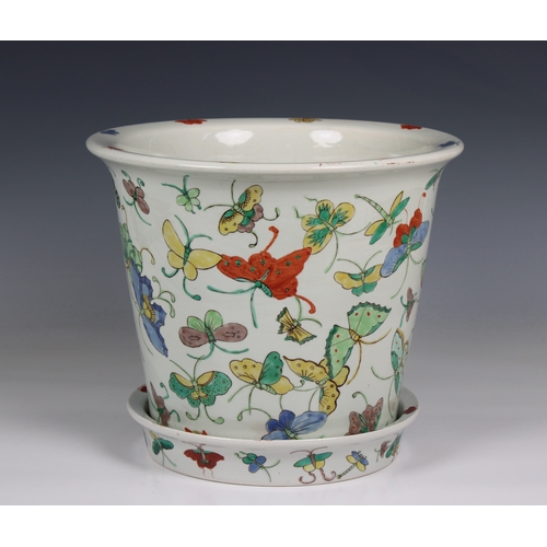 1180 - A 20th century Chinese porcelain jardiniere and saucer base decorated with polychrome butterflies, 1... 