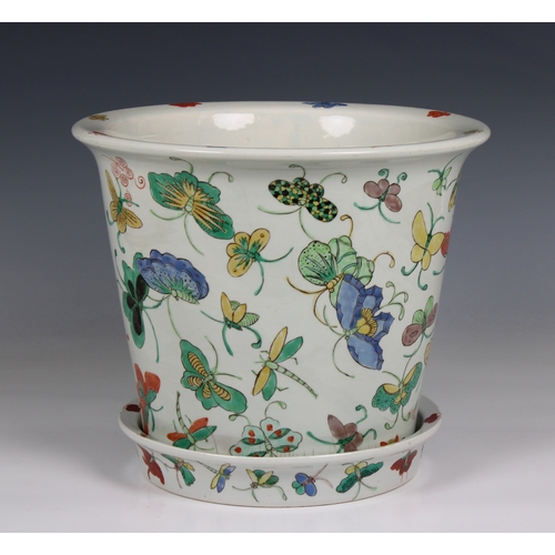 1180 - A 20th century Chinese porcelain jardiniere and saucer base decorated with polychrome butterflies, 1... 