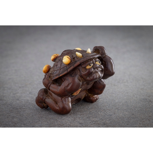 1222 - A WOOD NETSUKE OF A COWERING ONI Unsigned, Japan, Nagoya, 19th century, Edo period (1615-1868) The o... 