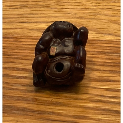 1222 - A WOOD NETSUKE OF A COWERING ONI Unsigned, Japan, Nagoya, 19th century, Edo period (1615-1868) The o... 