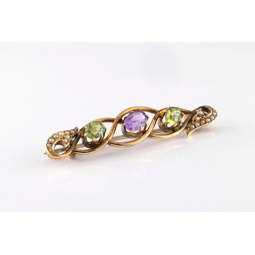 159 - An early 20th century yellow metal amethyst, peridot and seed pearl bar brooch in the suffragette co... 