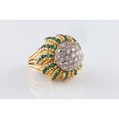 164 - A continental yellow gold diamond and emerald flowerhead bombe cocktail ring the circular domed cent... 