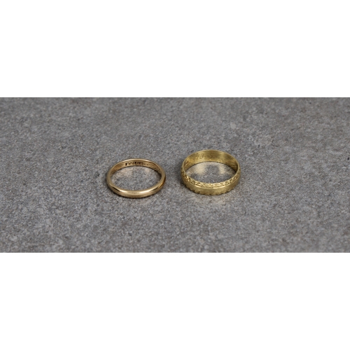 174 - Two 18ct yellow gold rings one of plain form, size K, the other a band with bright cut rims, inscrib... 