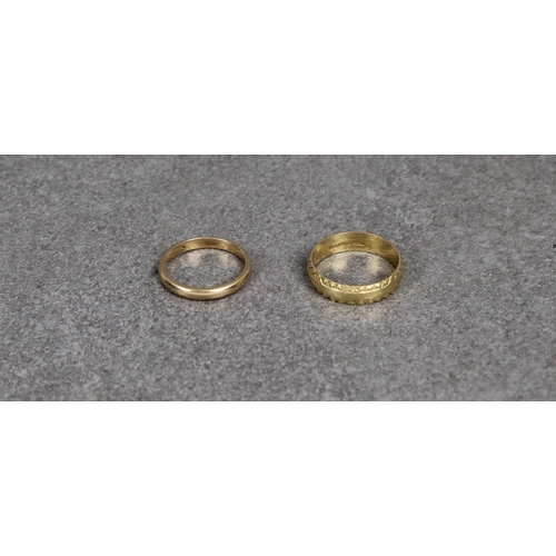 174 - Two 18ct yellow gold rings one of plain form, size K, the other a band with bright cut rims, inscrib... 