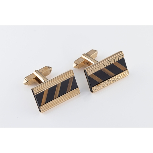 18 - A pair of 1970s 9ct gold onyx and tiger's eye cufflinks of rectangular form, having a central panel ... 