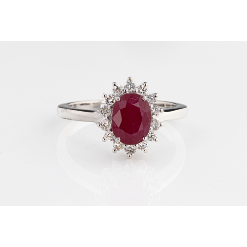 219 - An 18ct white gold ruby and diamond cluster ring the oval cut ruby approx 1.93cts, surrounded by rou... 