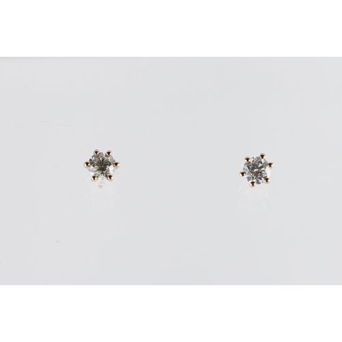 266 - A pair of 18ct rose gold and diamond solitaire stud earrings the round brilliant cut diamonds total ... 