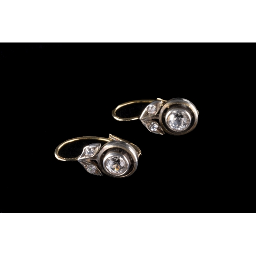 268 - A pair of Edwardian style yellow metal and white sapphire earrings set with a round cut stone in a c... 