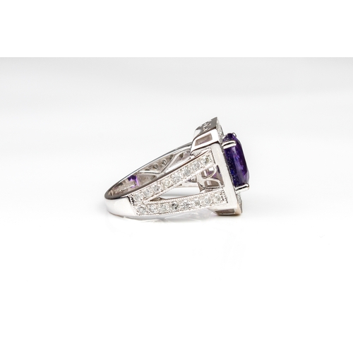 285 - An 18ct white gold, purple sapphire and diamond cluster ring Birmingham hallmarks, maker WEB, the ov... 