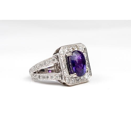 285 - An 18ct white gold, purple sapphire and diamond cluster ring Birmingham hallmarks, maker WEB, the ov... 