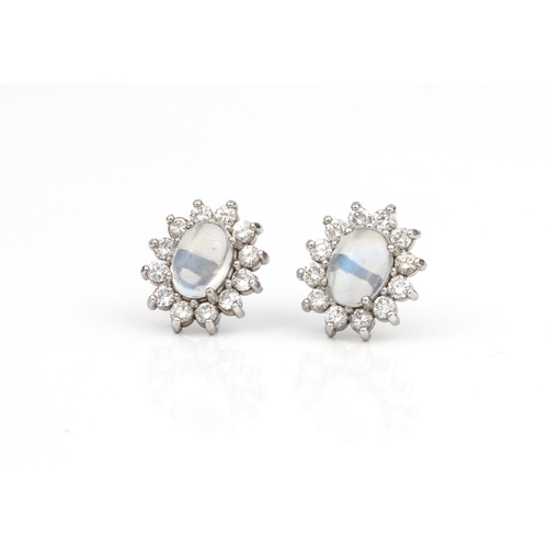 289 - A pair of 18ct white gold, moonstone and diamond cluster earrings the oval cabochon moonstones withi... 