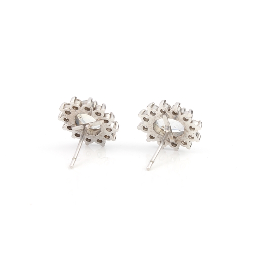 289 - A pair of 18ct white gold, moonstone and diamond cluster earrings the oval cabochon moonstones withi... 