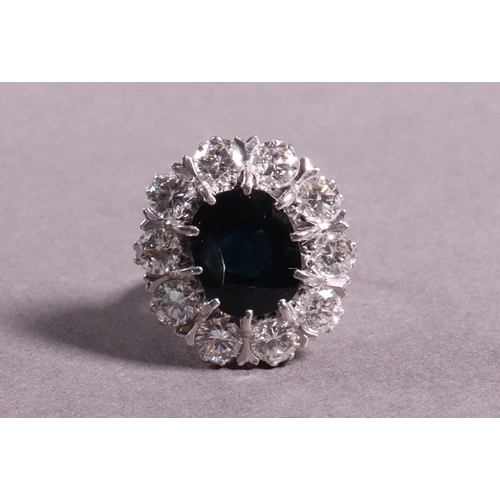 310 - A diamond and sapphire dress ring the central sapphire 5.5ct. approx surrounded by diamonds of 2.5ct... 