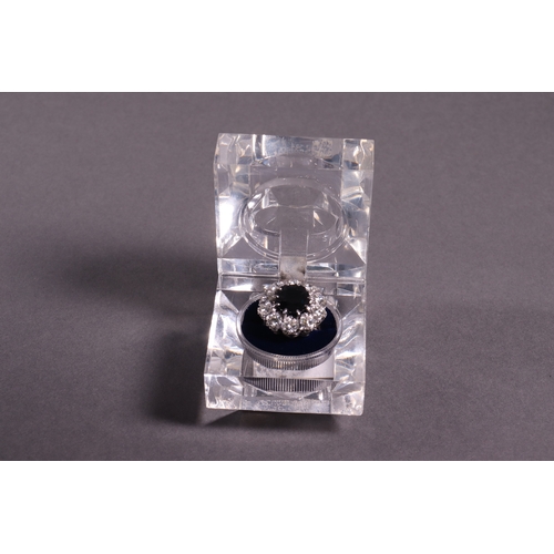 310 - A diamond and sapphire dress ring the central sapphire 5.5ct. approx surrounded by diamonds of 2.5ct... 