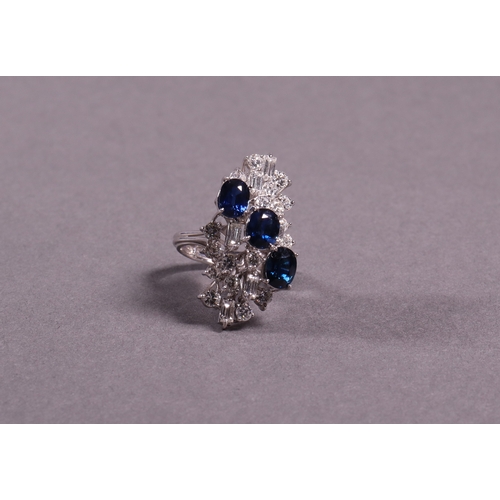 311 - A sapphire and diamond dress ring three sapphires set with 18 brilliant white diamonds and six bague... 