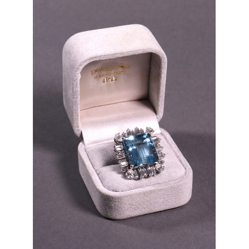 312 - An aquamarine and diamond set cluster ring comprising a single aquamarine surrounded by baguette and... 