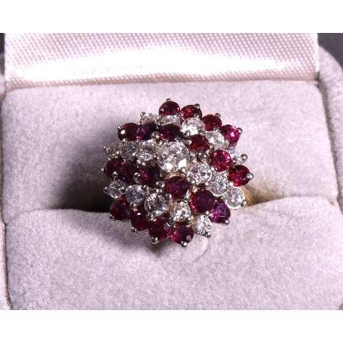 318 - A ruby and diamond cluster dress ring approx. 1.37ct diamonds, set in white and yellow gold.