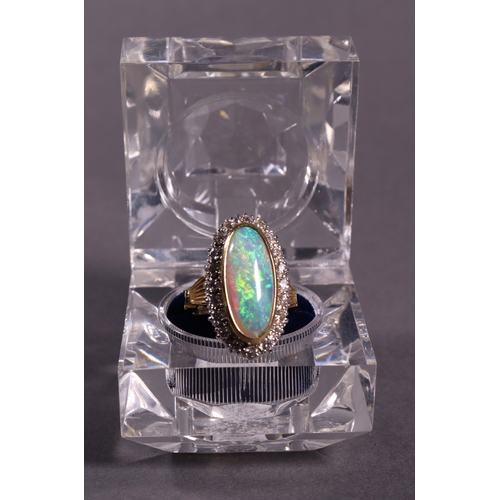 319 - An oblong opal and diamond dress ring set in 18ct. yellow gold.