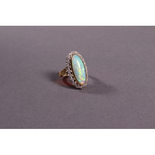 319 - An oblong opal and diamond dress ring set in 18ct. yellow gold.