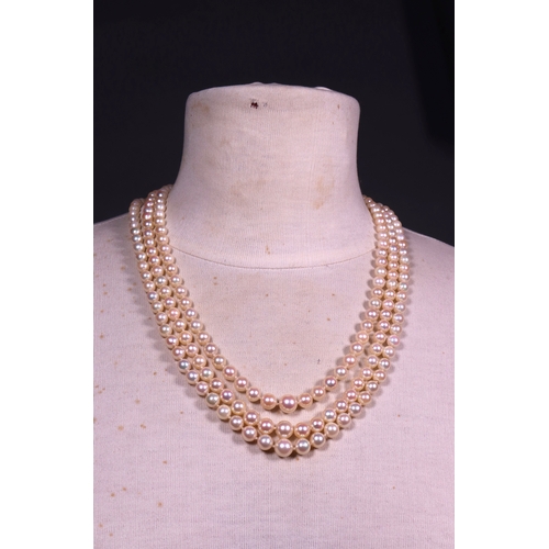 323 - A 3 row cultured pearl necklace with amethyst and pearl clasp in 9ct. gold.