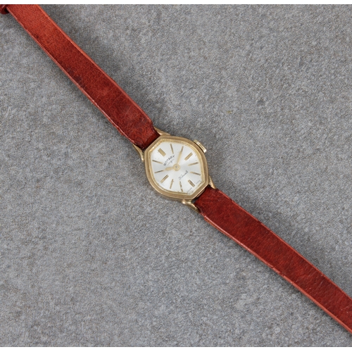 338 - A 9ct gold cased ladies Rotary small octagonal wrist watch with narrow leather strap.