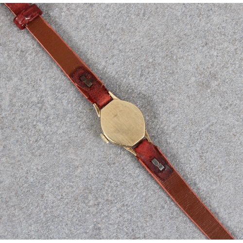 338 - A 9ct gold cased ladies Rotary small octagonal wrist watch with narrow leather strap.