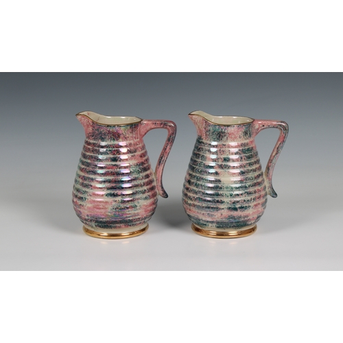 366 - A pair of 20th century Govancroft, Glasgow pottery lustre jugs mark beneath, 6 1/2 in. (16.5cm.) hig... 