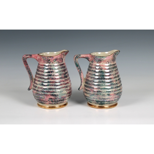 366 - A pair of 20th century Govancroft, Glasgow pottery lustre jugs mark beneath, 6 1/2 in. (16.5cm.) hig... 