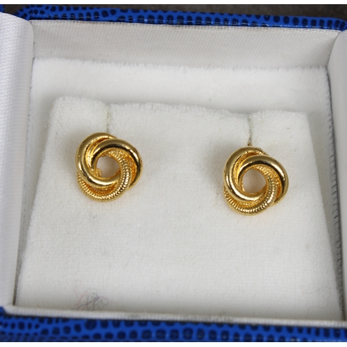 37 - A pair of 9ct gold cufflinks of rounded rectangular form with sprung bar fixings, each engraved with... 