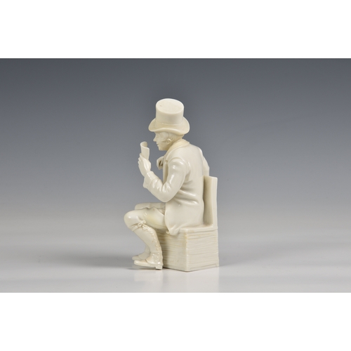 383 - A seated figure of a man in a top hat glazed white porcelain, 7½in. (19cm.) high.