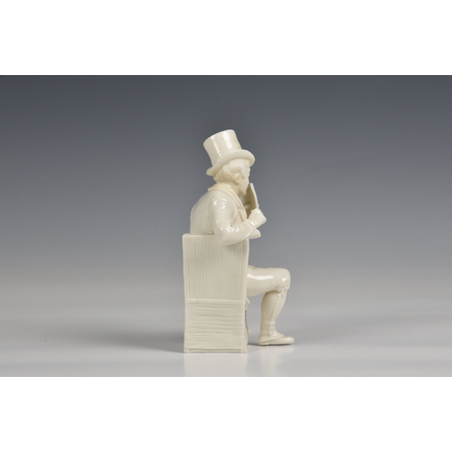 383 - A seated figure of a man in a top hat glazed white porcelain, 7½in. (19cm.) high.