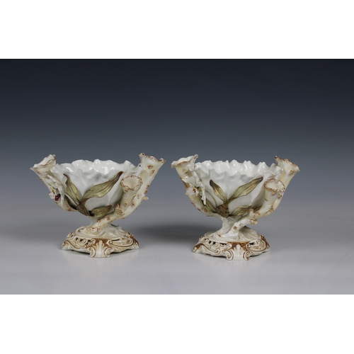 392 - Pair of Moore Bros. porcelain centerpiece bowls of organic form with a pinched rim, flanked by three... 