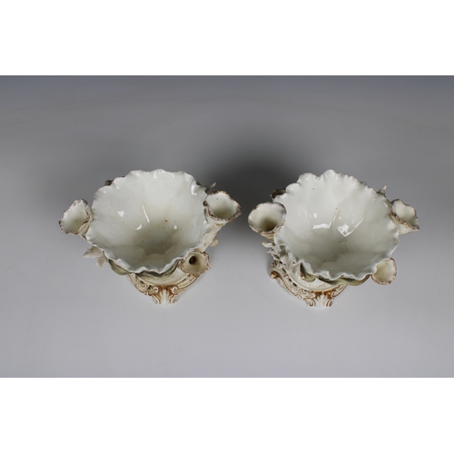 392 - Pair of Moore Bros. porcelain centerpiece bowls of organic form with a pinched rim, flanked by three... 