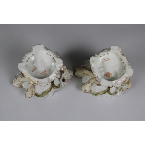 392 - Pair of Moore Bros. porcelain centerpiece bowls of organic form with a pinched rim, flanked by three... 