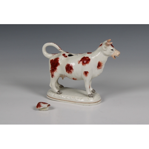 393 - A 19th century Staffordshire ceramic cow creamer 7in. (17.8cm.) long.