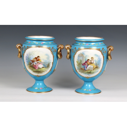 402 - A pair of 20th century blue porcelain vases each urn-form vase decorated with a romantic scene with ... 