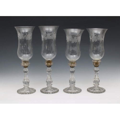 432 - Two pairs of late 19th century moulded clear glass candlesticks with clear glass storm lantern shade... 