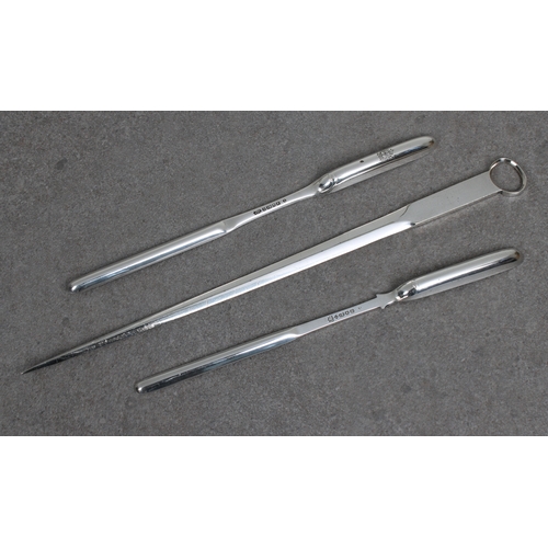 483 - Two silver plated double ended marrow scoops 8 7/8in. (22.7cm.) long, together with a plated skewer.... 