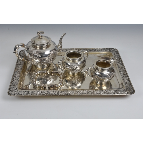 523 - A Chinese three piece silver tea set and tray - Mark of Luen Wo, Shanghai circa 1880-1925, comprisin... 