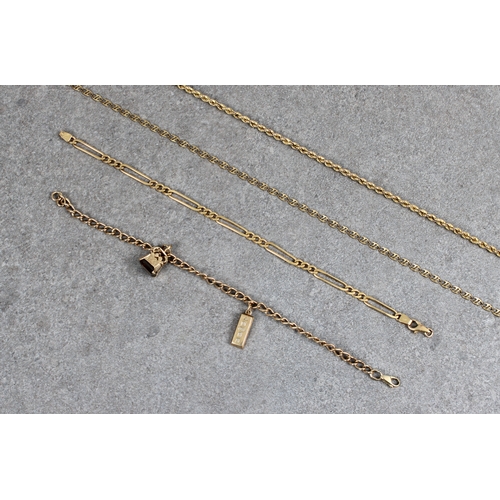 65 - A 9ct gold curb-link bracelet, approx 19.5cm long, suspending a 9ct gold ingot approx 2cm, and a 9ct... 