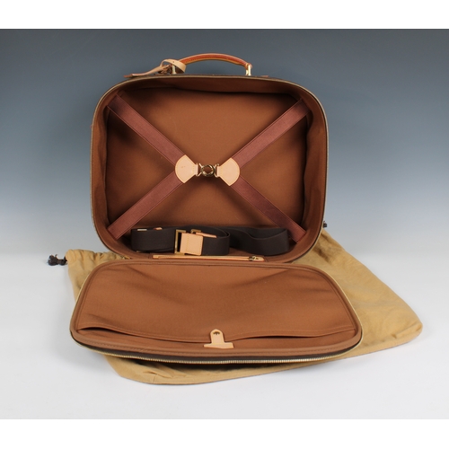 652 - A Louis Vuitton monogrammed travel case having monogrammed printed canvas, front zip pocket, full zi... 