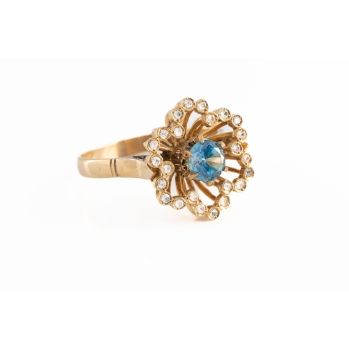 66 - An 18ct yellow gold zircon and diamond dress ring the central round cut blue zircon surrounded by si... 