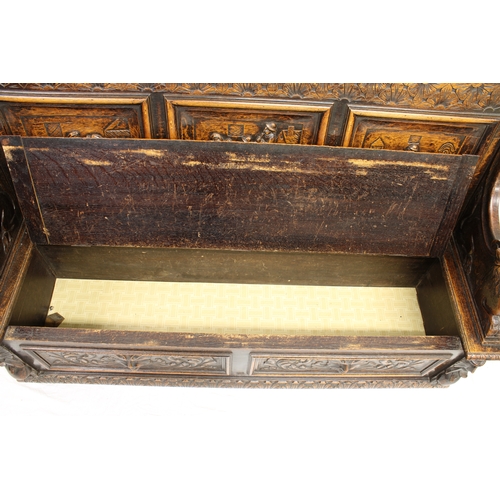 728 - A Victorian carved oak settle the back with three carved panels of tavern scenes, cavalier bust fini... 