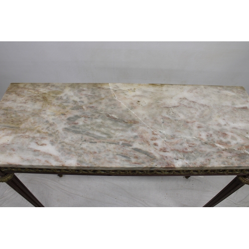 746 - A late 19th century marble top console table with a pale variegated marble top above an ornate freez... 